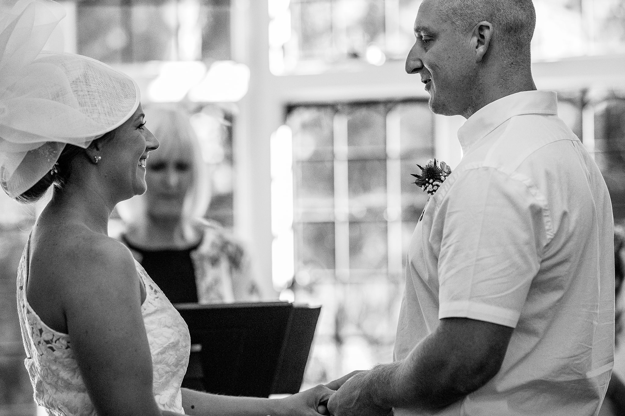 Black and white photo of bride and groom during ceremony taken by professional photographer Emma Seaney